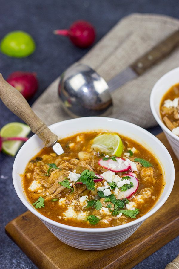 Slow Cooker Pork Posole is an easy dish to make on chilly Fall and Winter days.  It's packed with shredded pork and traditional Mexican flavors for a hearty and delicious meal!