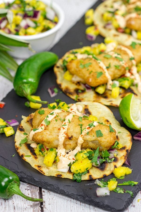These Spicy Fish Tostadas with Pineapple Salsa are a fun combination of sweet and savory flavors...and they're perfect for either weeknight or weekend meals!