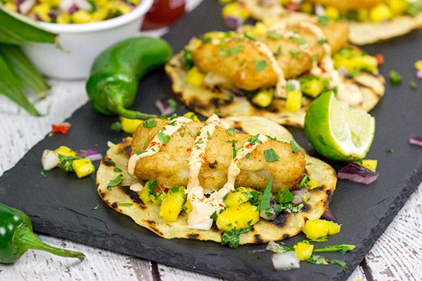 These Spicy Fish Tostadas with Pineapple Salsa are a fun combination of sweet and savory flavors...and they're perfect for either weeknight or weekend meals!