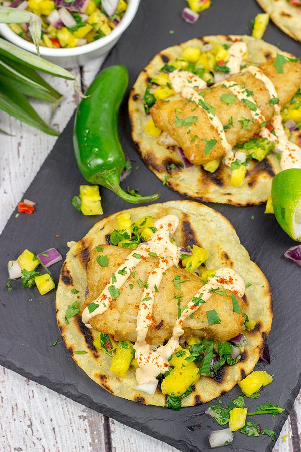 These Spicy Fish Tostadas with Pineapple Salsa are a fun combination of sweet and savory flavors...and they're perfect for either weeknight or weekend meals!