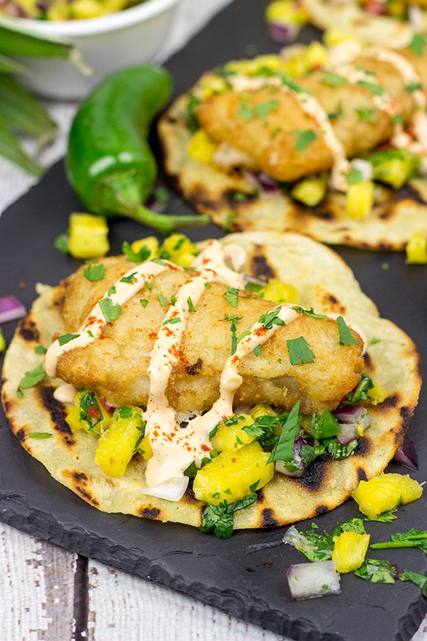 These Spicy Fish Tostadas with Pineapple Salsa are a fun combination of sweet and savory flavors...and they're perfect for either weeknight or weekend meals!