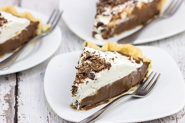 This classic Chocolate Cream Pie recipe features a silky smooth chocolate filling topped with creamy whipped cream.  Sprinkle some shaved chocolate on top, and you've got a delicious dessert to share!