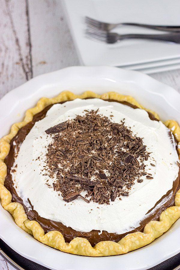 This classic Chocolate Cream Pie recipe features a silky smooth chocolate filling topped with creamy whipped cream.  Sprinkle some shaved chocolate on top, and you've got a delicious dessert to share!