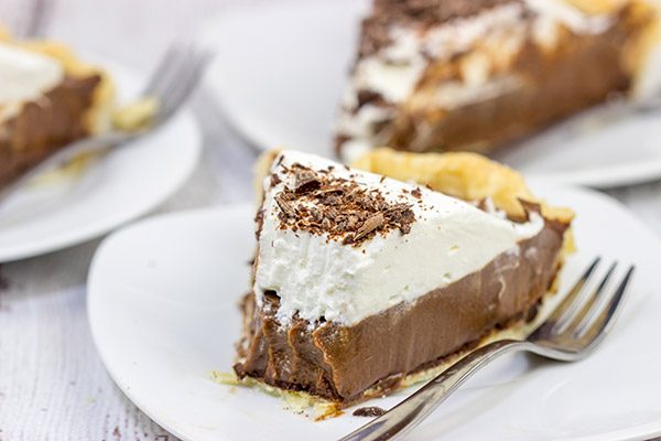 This classic Chocolate Cream Pie recipe features a silky smooth chocolate filling topped with creamy whipped cream.  Sprinkle some shaved chocolate on top, and you've got a delicious dessert to share!