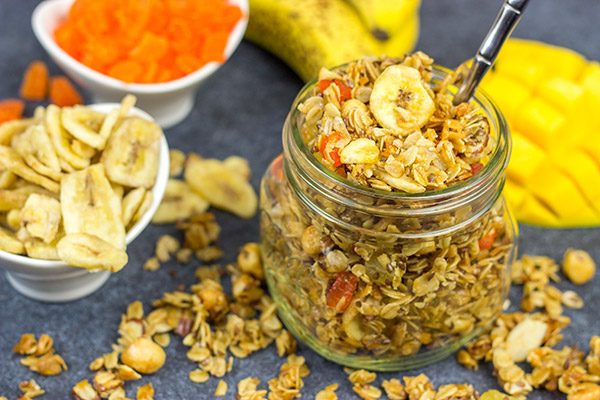 This Tropical Granola is packed with dried fruit, oats and nuts. Add a spoonful to a bowl of yogurt for breakfast or just it plain as a mid-afternoon snack!