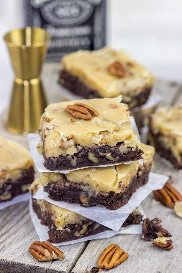 These Bourbon Pecan Brownies are a new favorite in our house!  These chewy, chocolatey brownies are topped with a brown sugar + bourbon + pecan frosting...and the result is delicious!
