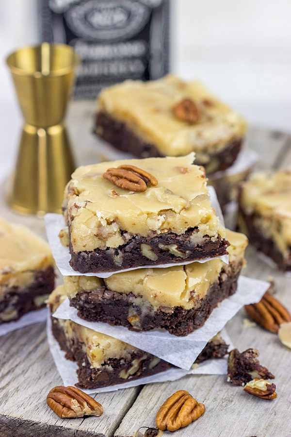 These Bourbon Pecan Brownies are a new favorite in our house! These chewy, chocolatey brownies are topped with a brown sugar + bourbon + pecan frosting...and the result is delicious!