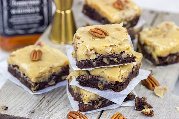 These Bourbon Pecan Brownies are a new favorite in our house!  These chewy, chocolatey brownies are topped with a brown sugar + bourbon + pecan frosting...and the result is delicious!