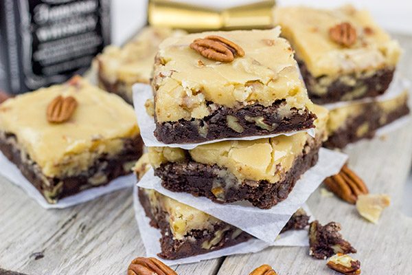 These Bourbon Pecan Brownies are a new favorite in our house!  These chewy, chocolatey brownies are topped with a brown sugar + bourbon + pecan frosting...and the result is delicious!