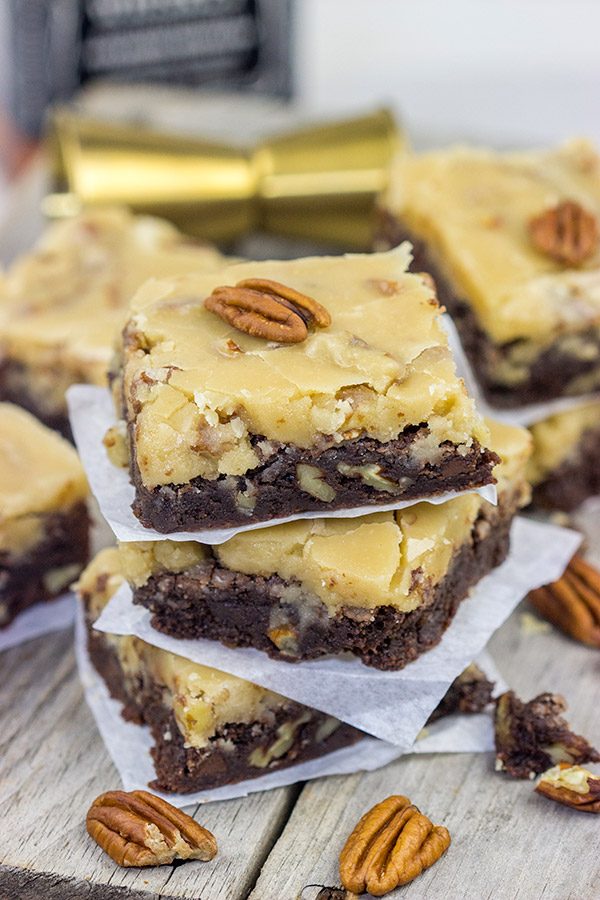 These Bourbon Pecan Brownies are a new favorite in our house!  These chewy, chocolatey brownies are topped with a brown sugar + bourbon + pecan frosting...and the result is delicious!