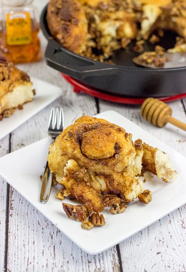 These Cast Iron Skillet Sticky Buns are topped with a tasty honey pecan glaze.  They're a surefire way to cure the winter blues!