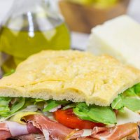 These Italian Prosciutto Panini start with a classic Tuscan bread called schiacciata. Add in some Prosciutto di Parma, marinated artichokes and Pecorino Romano, and you've got a delicious sandwich!
