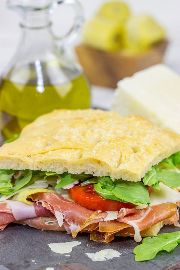 These Italian Prosciutto Panini start with a classic Tuscan bread called schiacciata. Add in some Prosciutto di Parma, marinated artichokes and Pecorino Romano, and you've got a delicious sandwich!