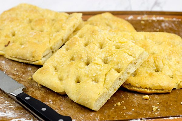These Italian Prosciutto Panini start with a classic Tuscan bread called schiacciata.  Add in some Prosciutto di Parma, marinated artichokes and Pecorino Romano, and you've got a delicious sandwich!