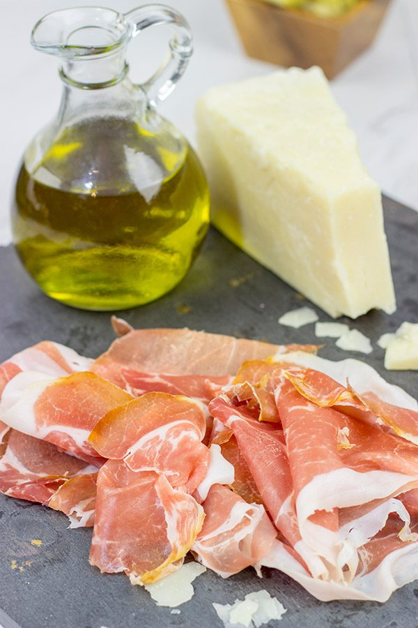 These Italian Prosciutto Panini start with a classic Tuscan bread called schiacciata.  Add in some Prosciutto di Parma, marinated artichokes and Pecorino Romano, and you've got a delicious sandwich!
