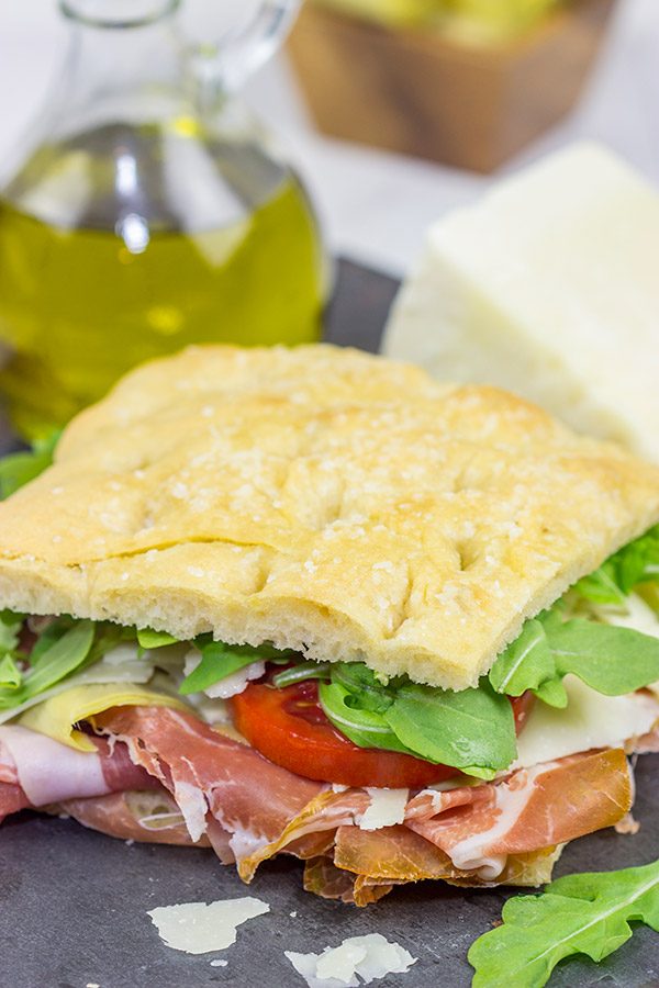 These Italian Prosciutto Panini start with a classic Tuscan bread called schiacciata.  Add in some Prosciutto di Parma, marinated artichokes and Pecorino Romano, and you've got a delicious sandwich!