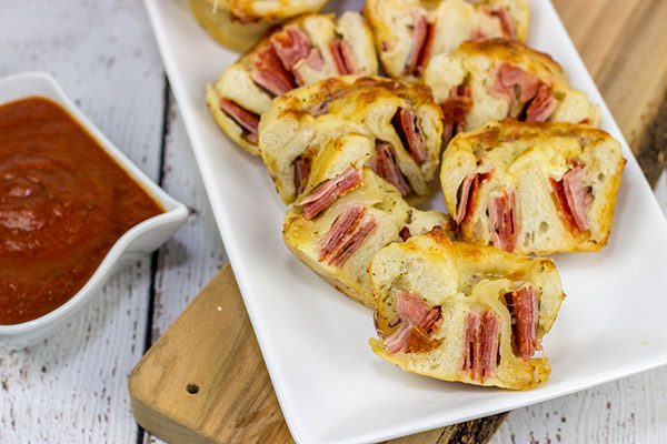 Muffin tins can be used for more than just breakfast!  These Muffin Tin Stromboli are packed with Italian meats and cheeses, and they're the perfect football appetizer!