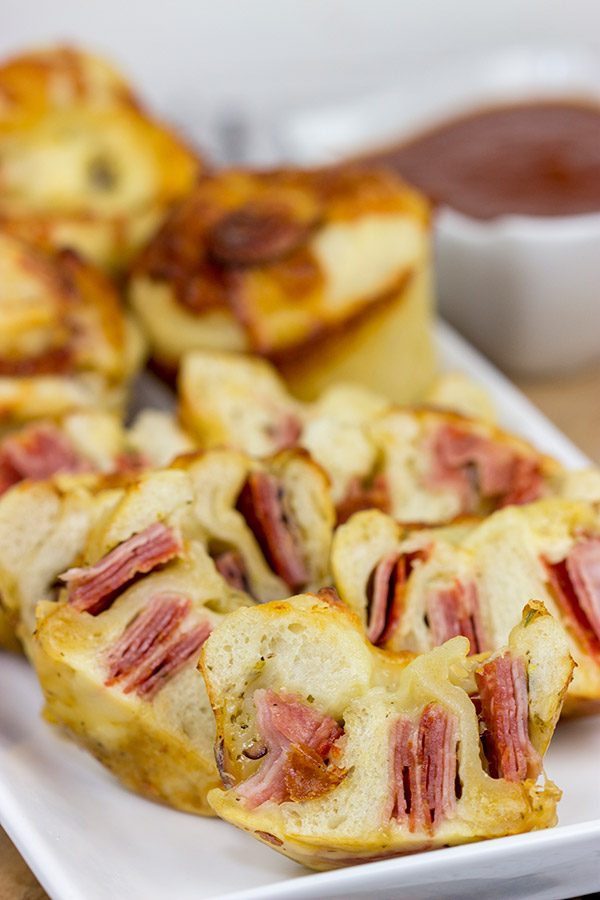 Muffin tins can be used for more than just breakfast!  These Muffin Tin Stromboli are packed with Italian meats and cheeses, and they're the perfect football appetizer!