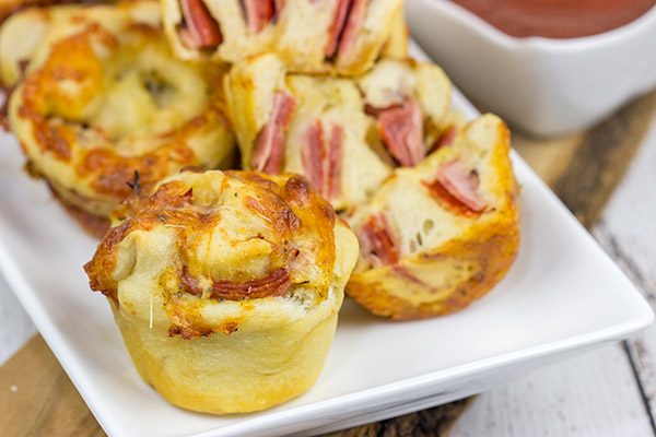 Muffin tins can be used for more than just breakfast!  These Muffin Tin Stromboli are packed with Italian meats and cheeses, and they're the perfect football appetizer!