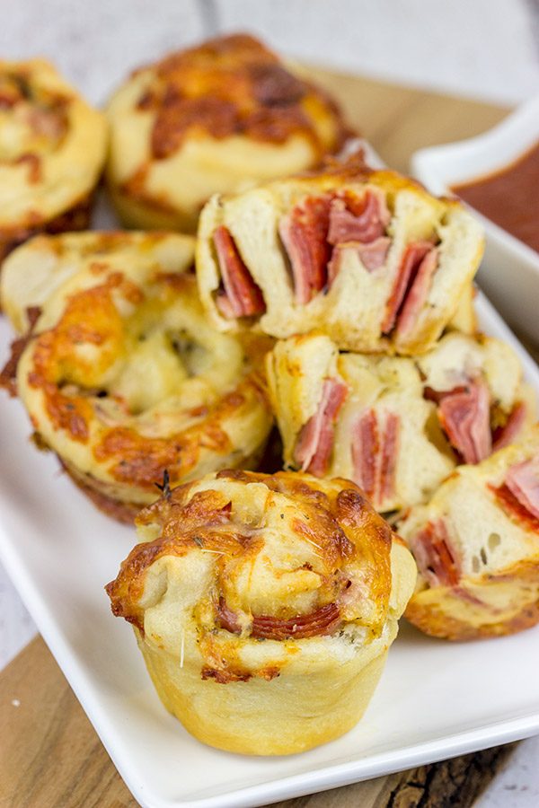 Muffin tins can be used for more than just breakfast!  These Muffin Tin Stromboli are packed with Italian meats and cheeses, and they're the perfect football appetizer!