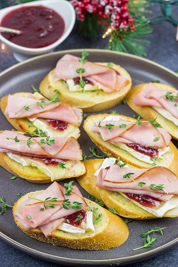 Looking for a fun way to elevate your holiday appetizers?  These Ham, Brie and Cranberry Crostini are layered with tasty flavors, and they're a cinch to make!