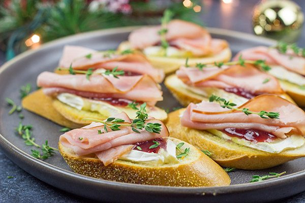 Looking for a fun way to elevate your holiday appetizers?  These Ham, Brie and Cranberry Crostini are layered with tasty flavors, and they're a cinch to make!