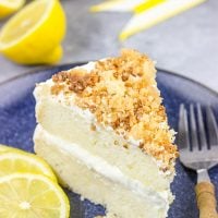 This Lemon Cream Cake features layers of delicious lemon cake topped with a light whipped frosting and crunchy crumbles!