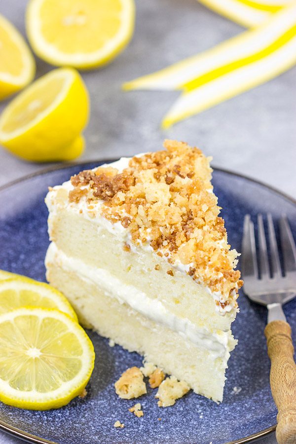 This Lemon Cream Cake features layers of delicious lemon cake topped with a light whipped frosting and crunchy crumbles!