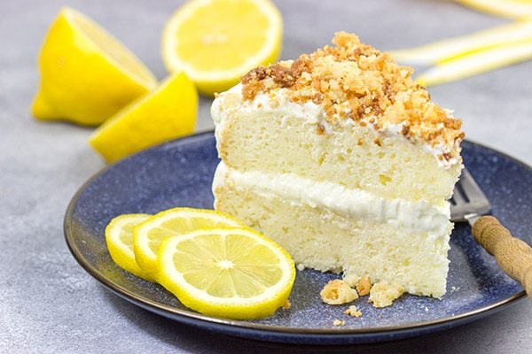This Lemon Cream Cake features layers of delicious lemon cake topped with a light whipped frosting and crunchy crumbles!