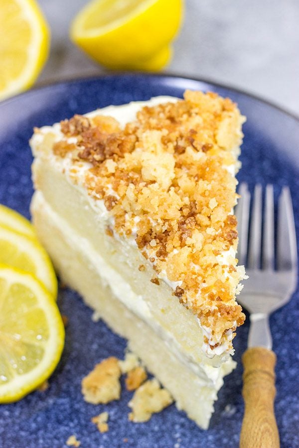 This Lemon Cream Cake features layers of delicious lemon cake topped with a light whipped frosting and crunchy crumbles!