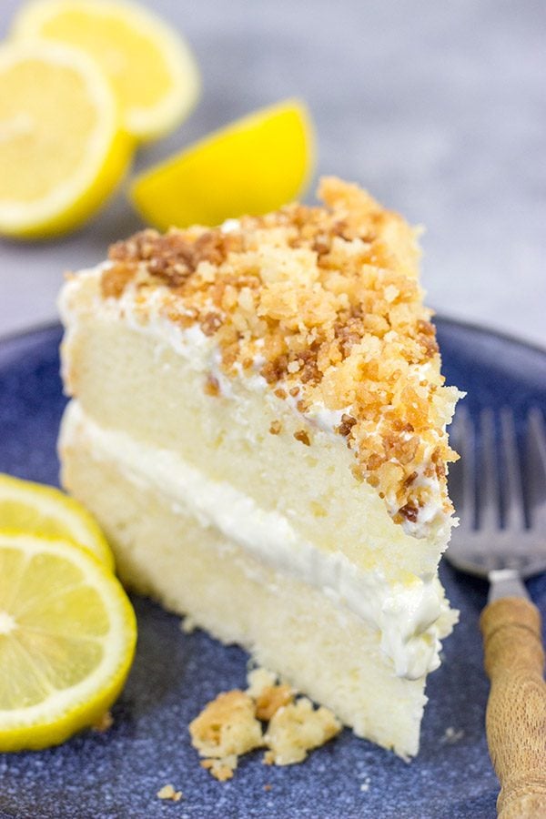 This Lemon Cream Cake features layers of delicious lemon cake topped with a light whipped frosting and crunchy crumbles!