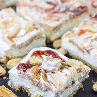 These PB&J Cheesecake Bars are an easy and delicious way to celebrate National Peanut Butter and Jelly Day! (They're also a great dessert for any other day of the year, too!)