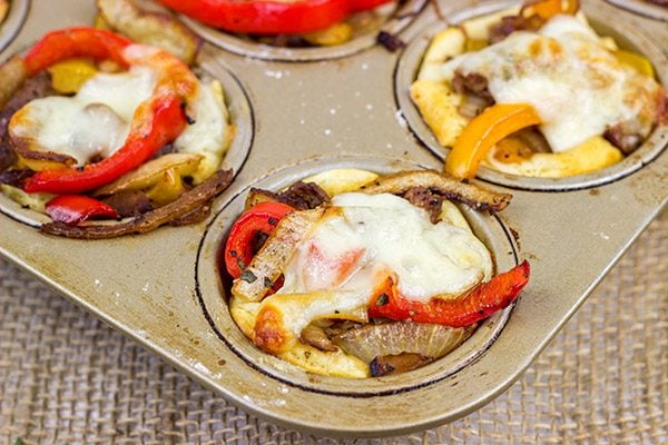These Philly Cheesesteak Cups feature ribeye steak, peppers and onions all baked in mini crescent roll cups. They're the perfect comfort food appetizer for football season!