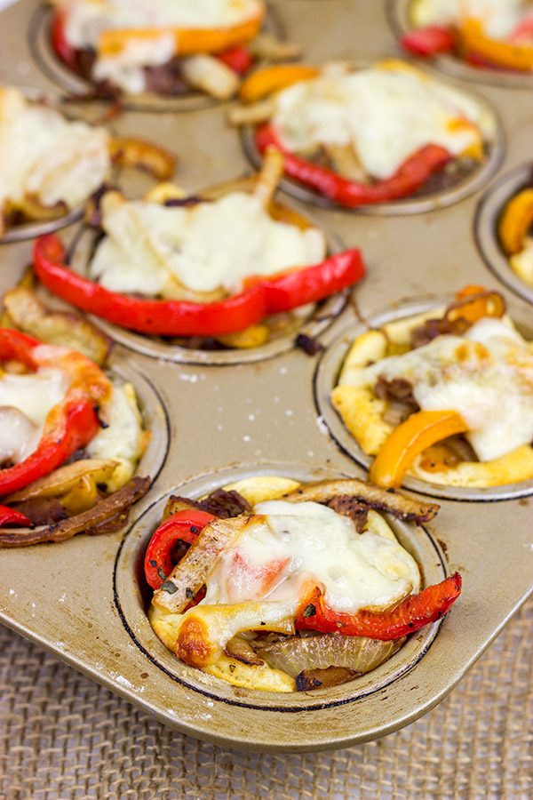 These Philly Cheesesteak Cups feature ribeye steak, peppers and onions all baked in mini crescent roll cups. They're the perfect comfort food appetizer for football season!