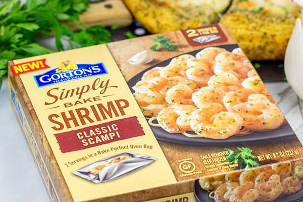 This Shrimp Scampi Pizza is the perfect football food!  Perfectly cooked shrimp combined with a flavorful garlic white sauce make this pizza a tasty option for the big game!