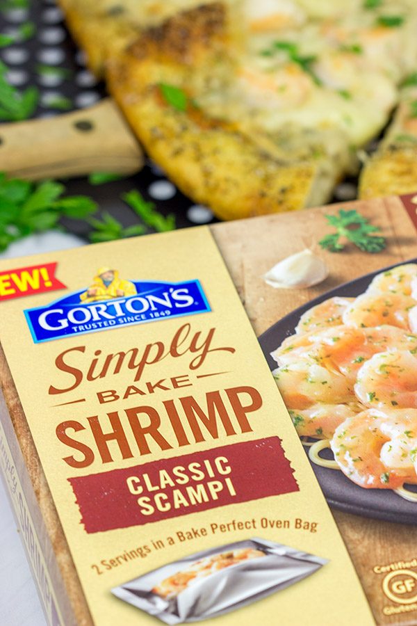 This Shrimp Scampi Pizza is the perfect football food!  Perfectly cooked shrimp combined with a flavorful garlic white sauce make this pizza a tasty option for the big game!