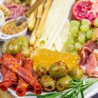 A Holiday Charcuterie Board is a great addition to any holiday party. Here are some and tricks for turning your cheese board into the talk of the party!