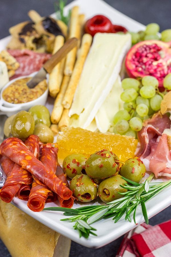 A Holiday Charcuterie Board is a great addition to any holiday party. Here are some and tricks for turning your cheese board into the talk of the party!