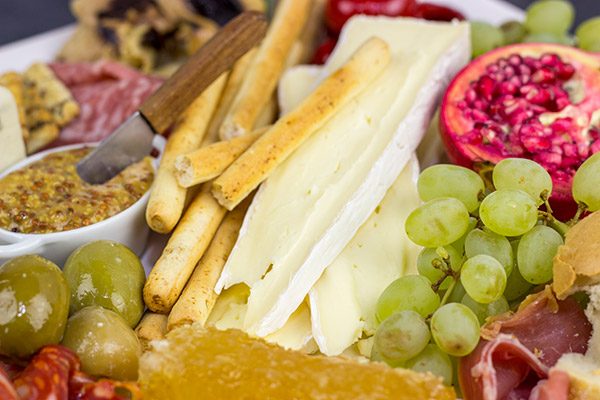 A Holiday Charcuterie Board is a great addition to any holiday party.  Here are some and tricks for turning your cheese board into the talk of the party!