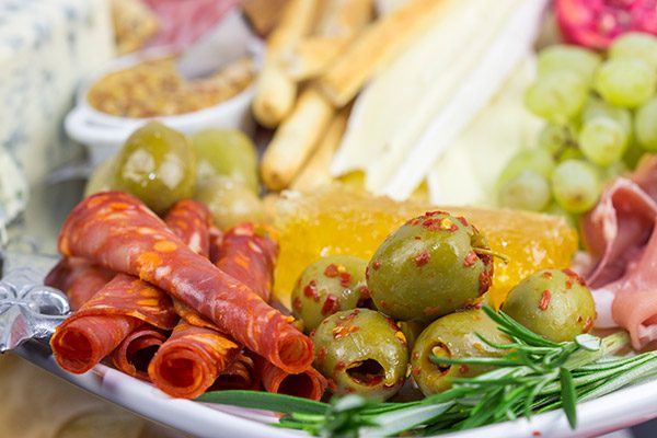 A Holiday Charcuterie Board is a great addition to any holiday party.  Here are some and tricks for turning your cheese board into the talk of the party!