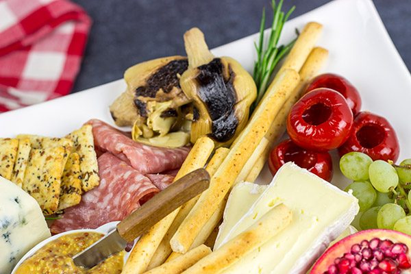 A Holiday Charcuterie Board is a great addition to any holiday party.  Here are some and tricks for turning your cheese board into the talk of the party!