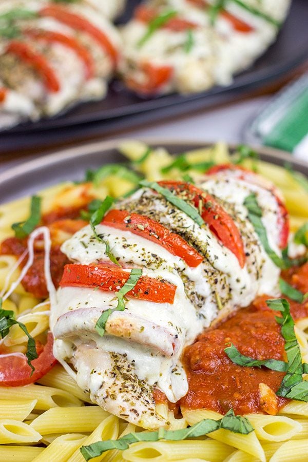 Filled with creamy mozzarella cheese, Roma tomatoes and freshly chopped basil, this Stuffed Chicken Caprese recipe is a new favorite in our house!