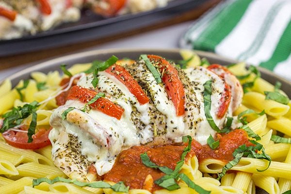 Filled with creamy mozzarella cheese, Roma tomatoes and freshly chopped basil, this Stuffed Chicken Caprese recipe is a new favorite in our house!