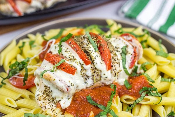 Filled with creamy mozzarella cheese, Roma tomatoes and freshly chopped basil, this Stuffed Chicken Caprese recipe is a new favorite in our house!