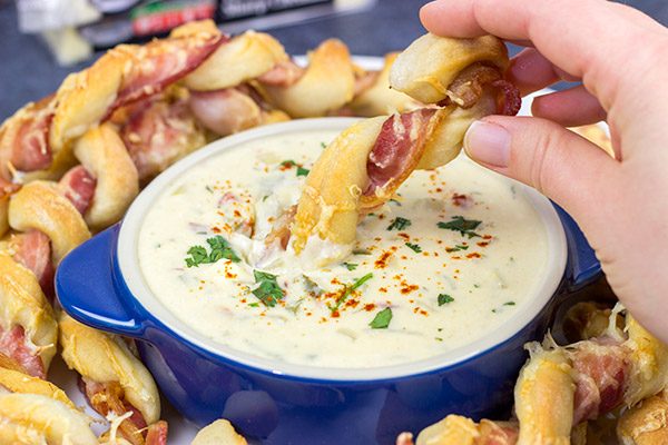 Bacon.  Cheese.  Breadsticks.  What else do you need?  These Bacon Wrapped Breadsticks with Queso are a unique and delicious football party appetizer!