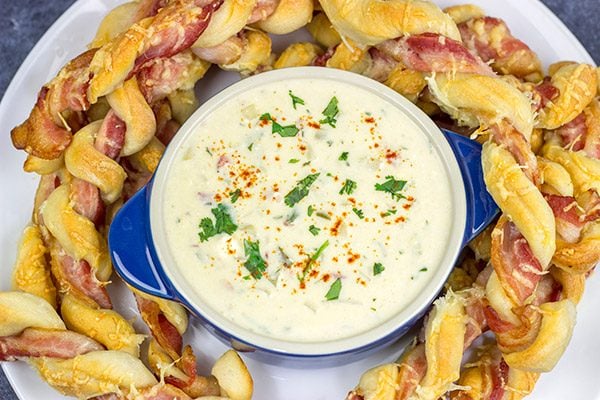 Bacon.  Cheese.  Breadsticks.  What else do you need?  These Bacon Wrapped Breadsticks with Queso are a unique and delicious football party appetizer!