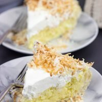 Topped with lightly toasted coconut flakes, this Coconut Cream Pie is a classic summer dessert! Grab a fork and dig in!