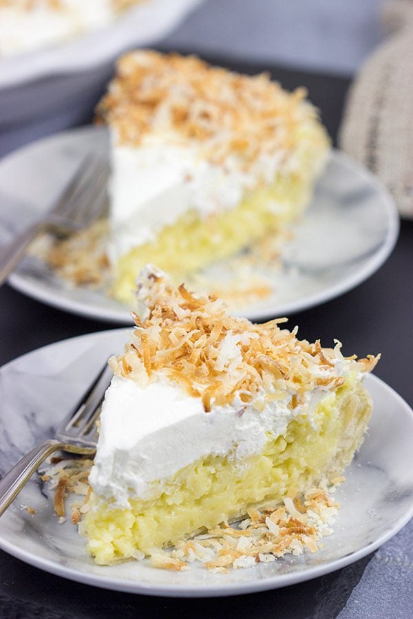 Topped with lightly toasted coconut flakes, this Coconut Cream Pie is a classic summer dessert!  Grab a fork and dig in!