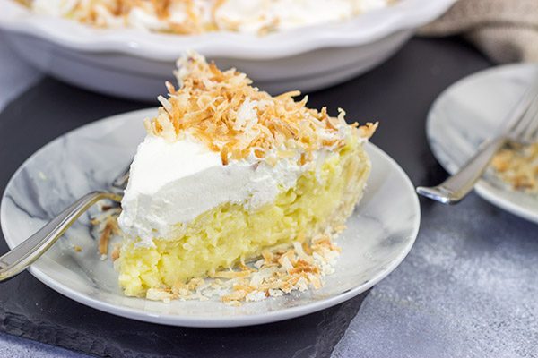 Topped with lightly toasted coconut flakes, this Coconut Cream Pie is a classic summer dessert!  Grab a fork and dig in!