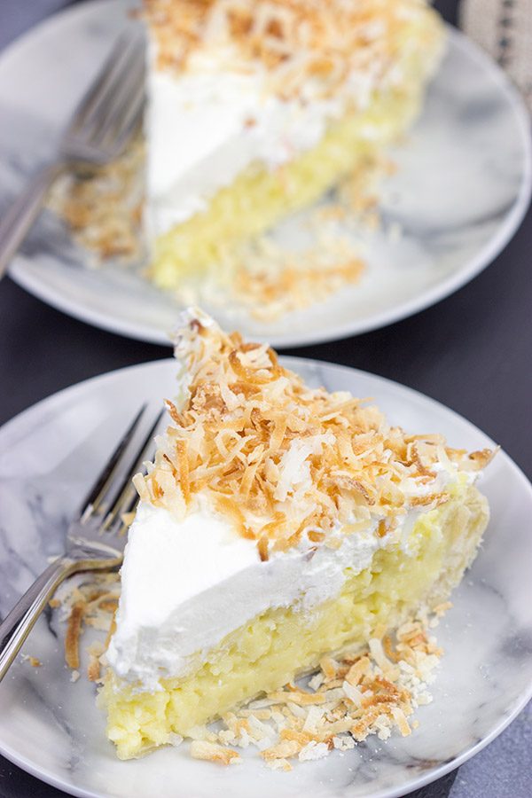 Topped with lightly toasted coconut flakes, this Coconut Cream Pie is a classic summer dessert!  Grab a fork and dig in!